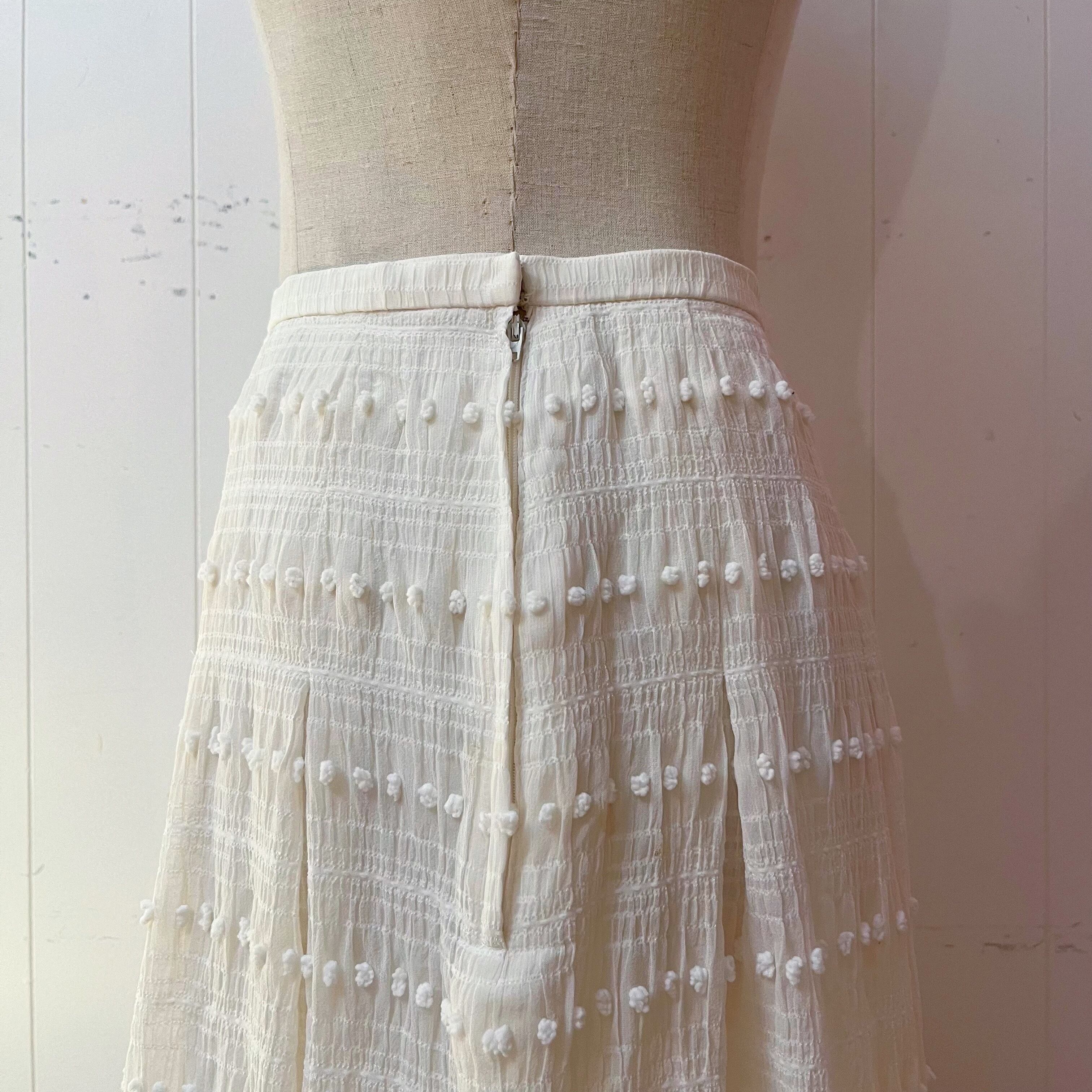 NINARICCI / mini ponpon white flare skirt