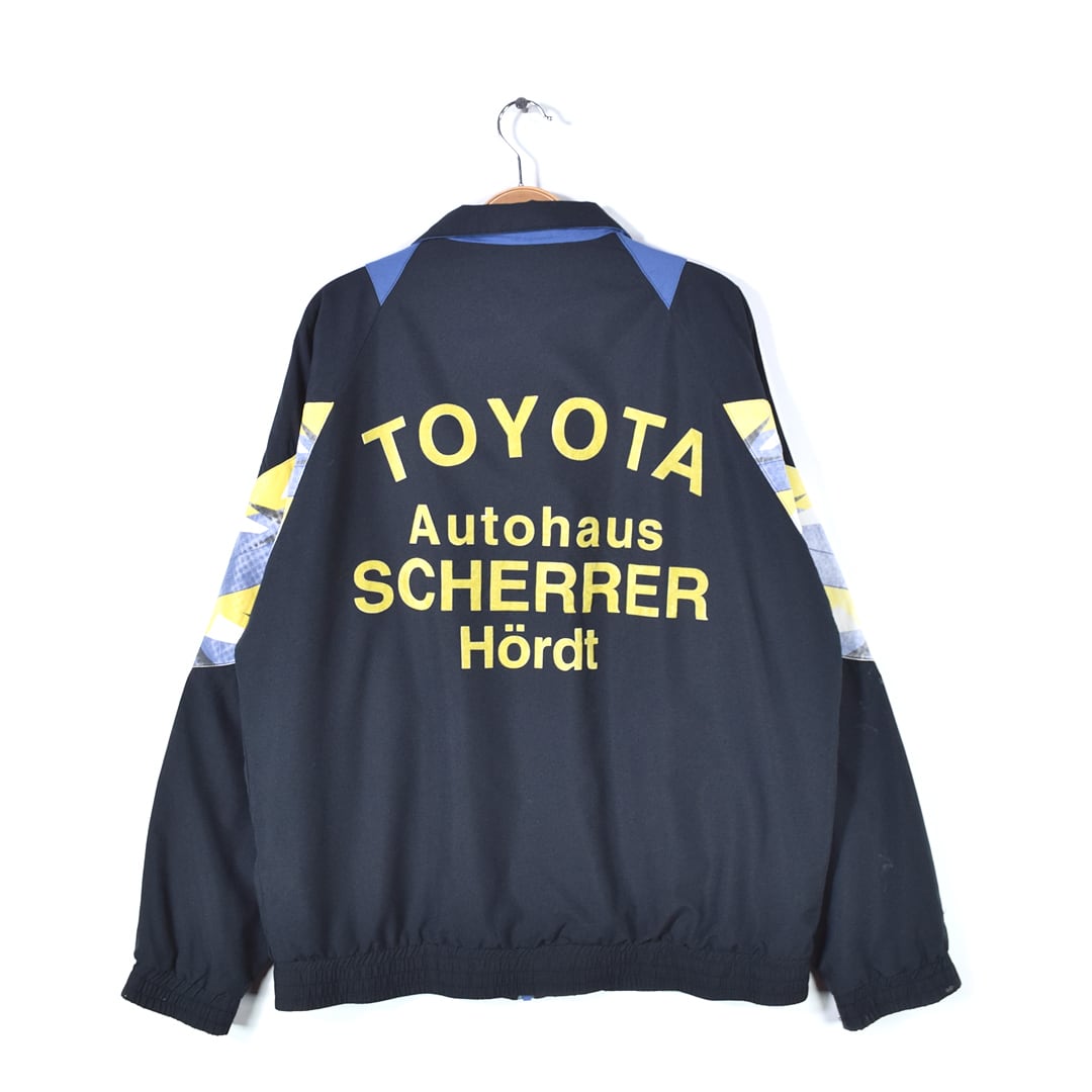 80s アディダス ヴィンテージナイロンジャケット トラックジャケット 企業系 バックプリント TOYOTAトヨタ ドルマンスリーブ adidas サイズL相当 古着 @CK0196