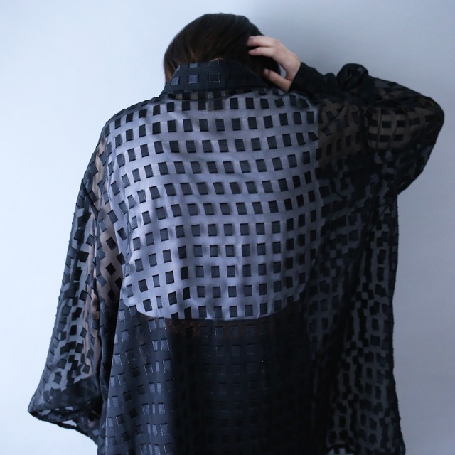 block pattern XXX over silhouette black see-through shirt