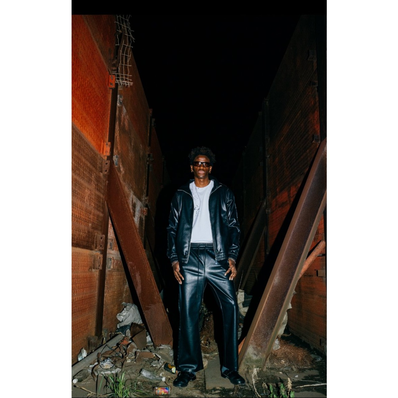 LAST NEST / faux leather track pants