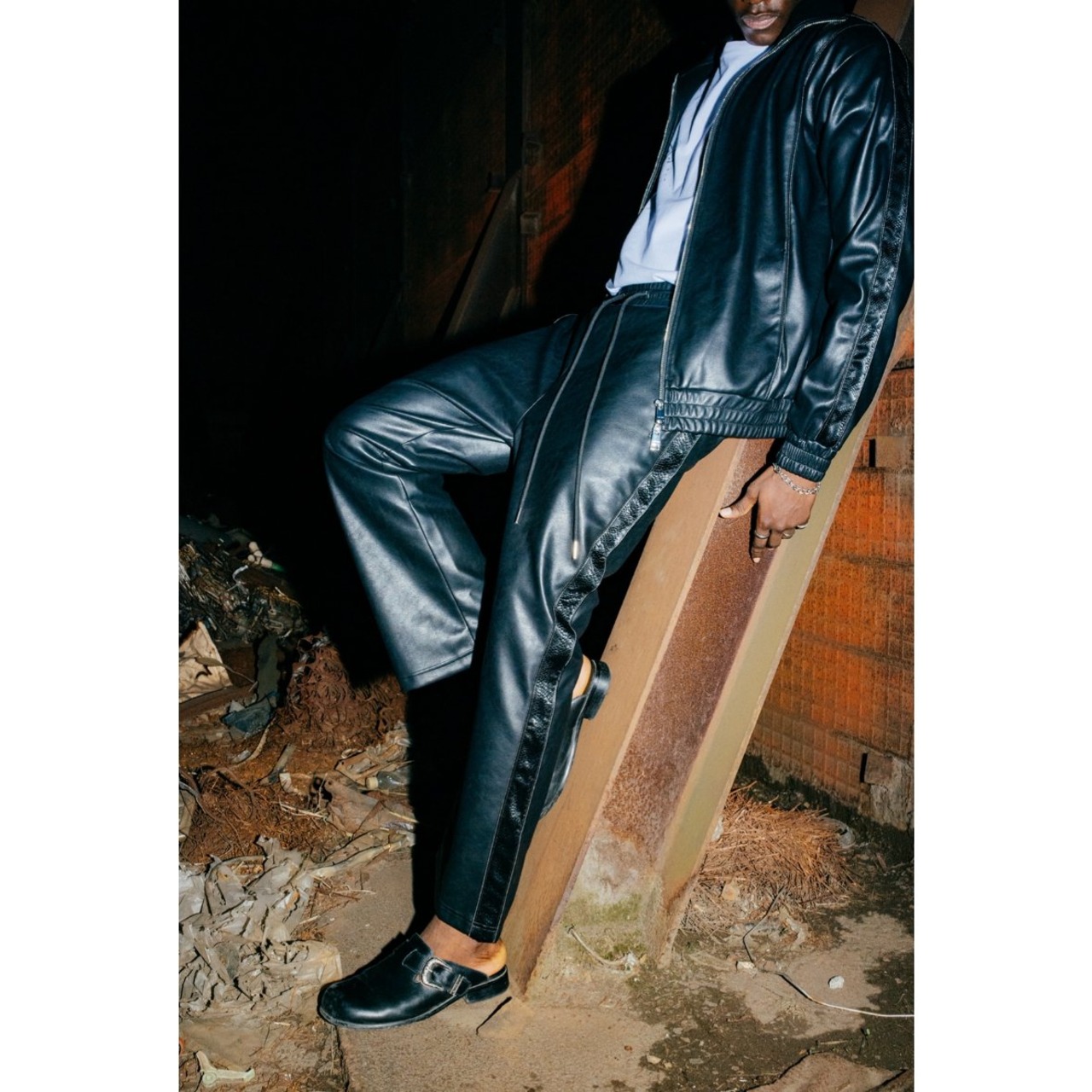 LAST NEST / faux leather track pants