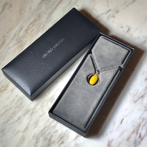 2011's GEORG JENSEN silver annual pendant set with yellow agete