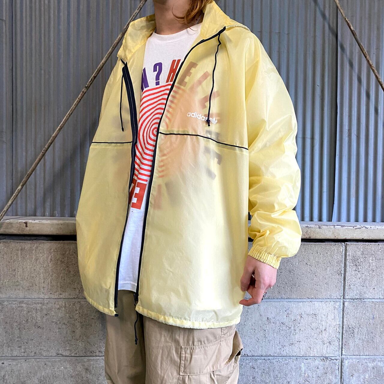 80年代 Adidas アディダス トレフォイルロゴ プリント スースルー ナイロンジャケット メンズxl相当 古着 袖ライン 80s 90s ビンテージ ヴィンテージ イエロー 黄色 パッカブル フード収納式 ナイロンジャケット Cave 古着屋 公式 古着通販サイト