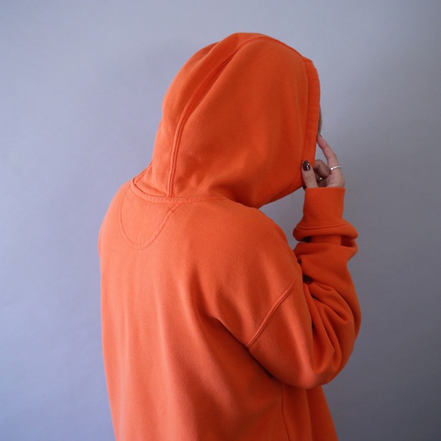 "Carhartt" sleeve logo printed over silhouette orange sweat parka