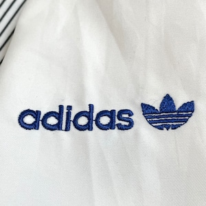 【adidas】90s トラックジャケット ジャンパー ブルゾン 刺繍ロゴ フルジップ バックプリント 切替 銀タグ 万国旗タグ アディダス US古着