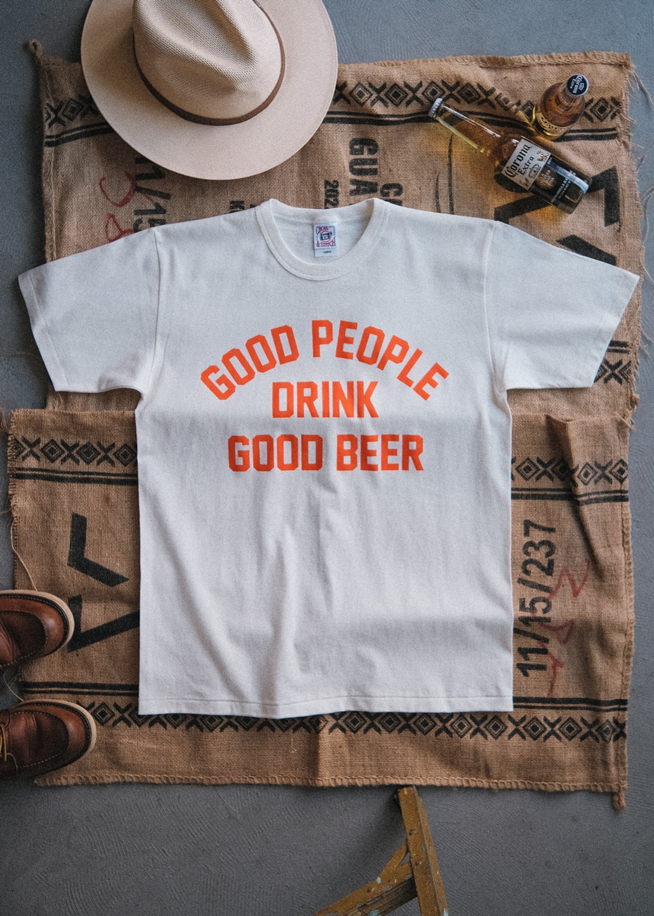 the "GOOD PEOPLE DRINK GOOD BEER" letterpress tee in natural / orange ink（受注生産）