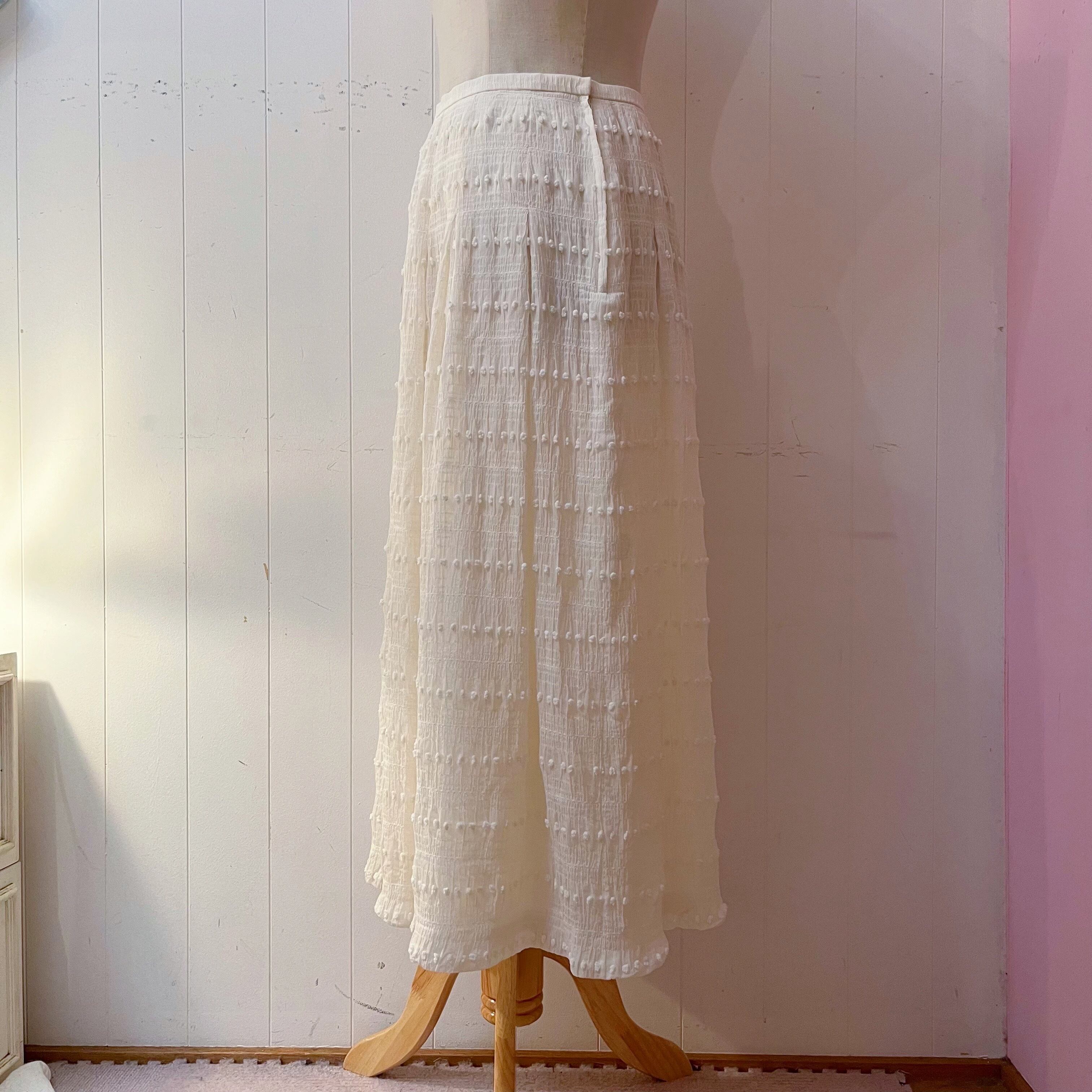 NINARICCI / mini ponpon white flare skirt