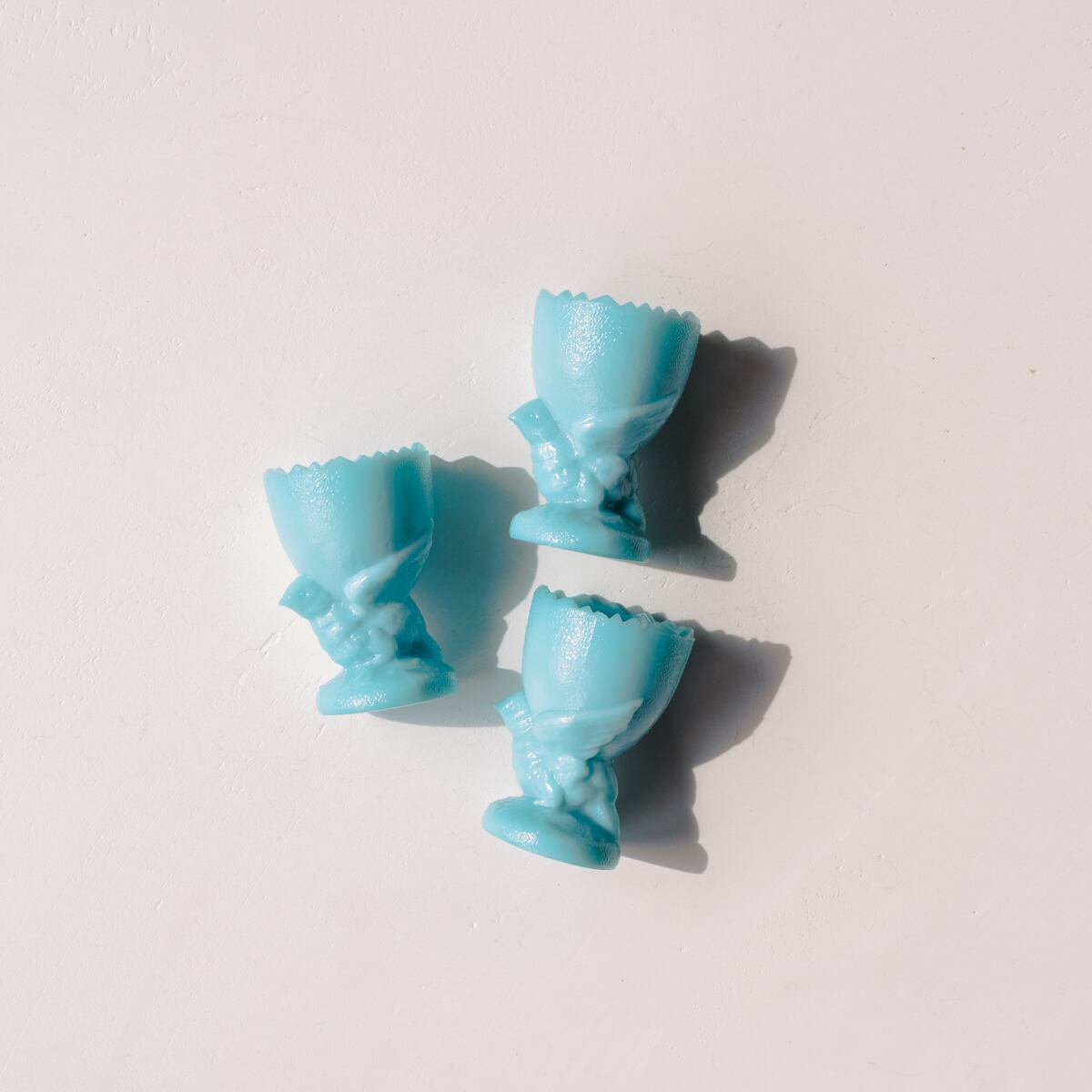 Milky Egg Stand supported by a bird