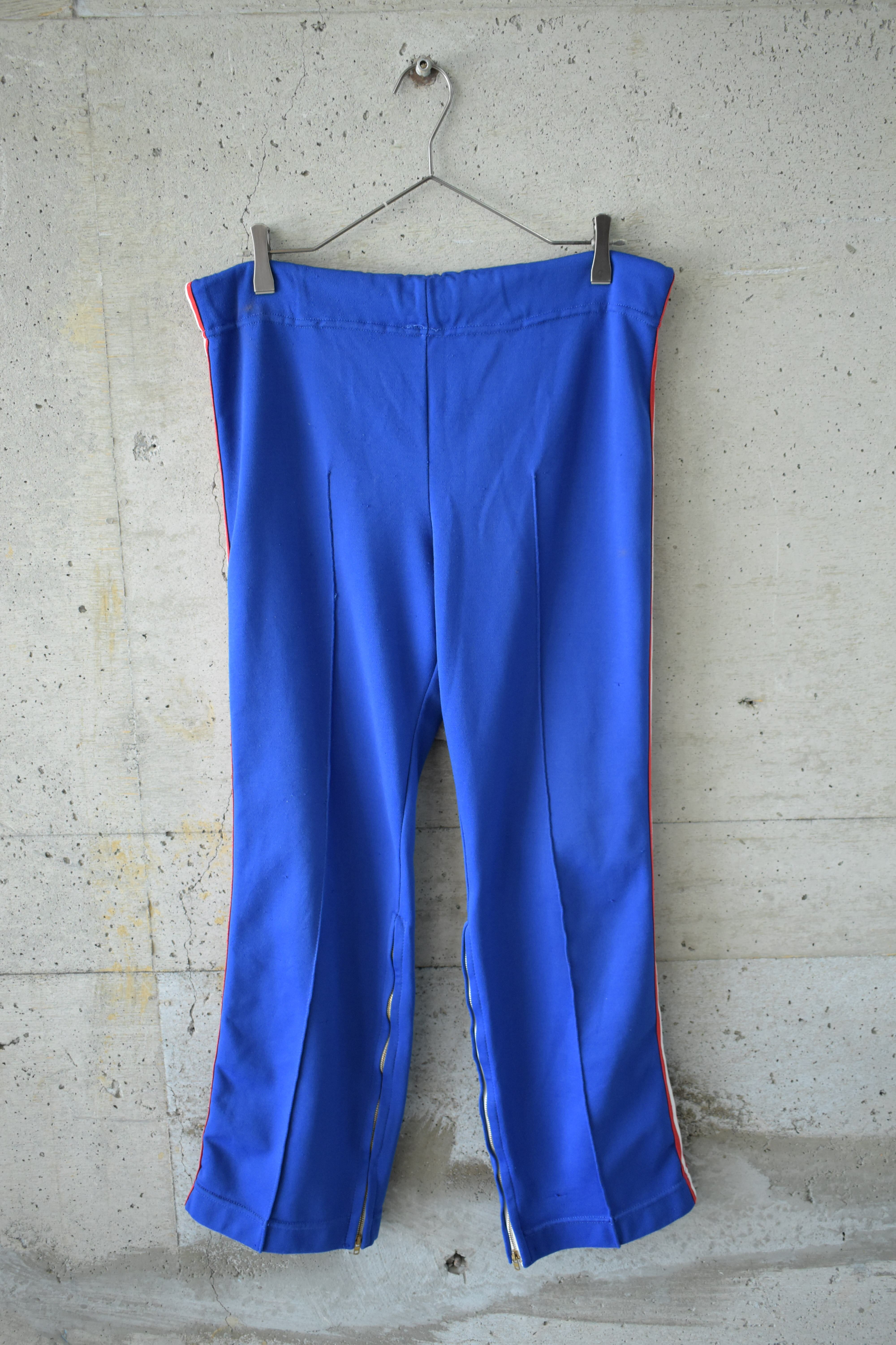 Blue track pants with zippered hems