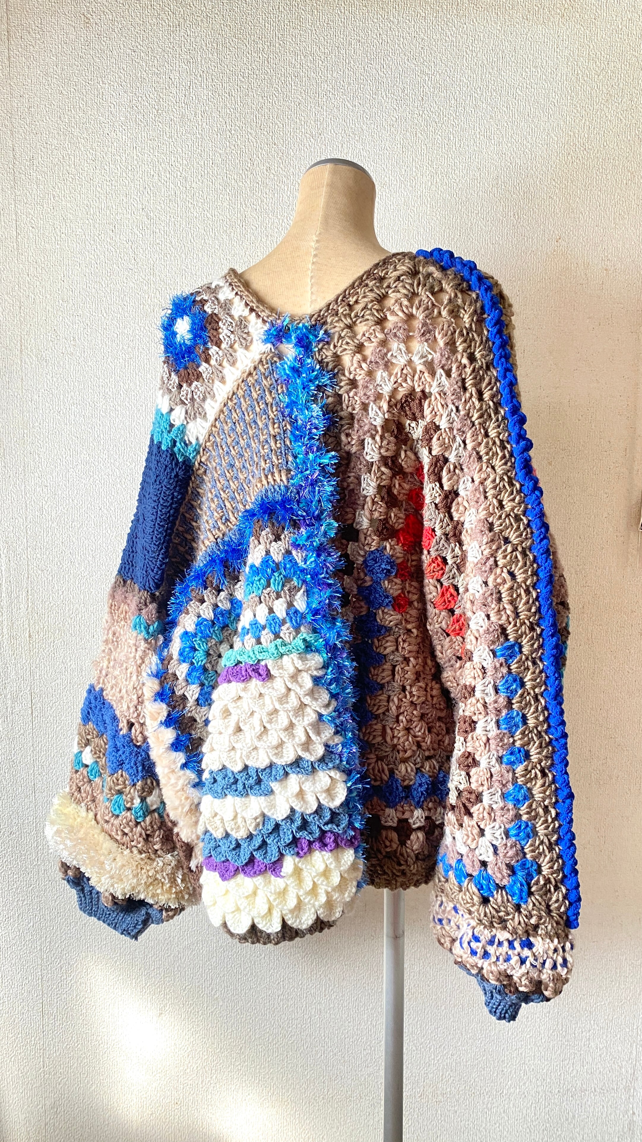 Crocheted granny hexagon and square motif asymmetrical cardigan