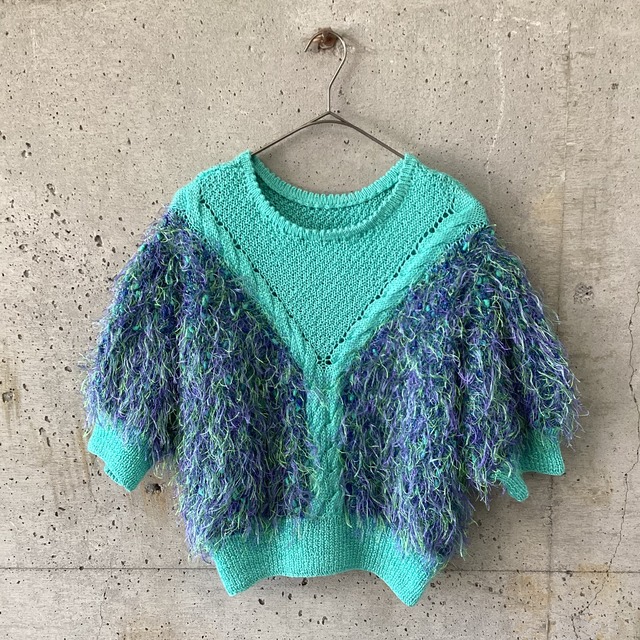 green knit vest with lots of buttons