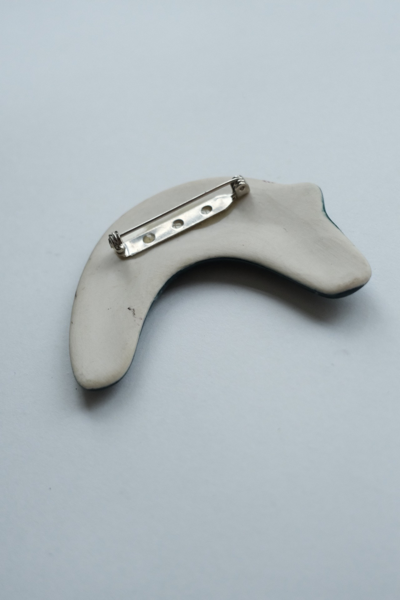 Handmade ceramic crescent cat brooch