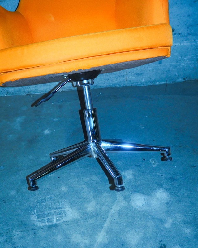 Orange swivel/height-adjustable shell-style personal chair