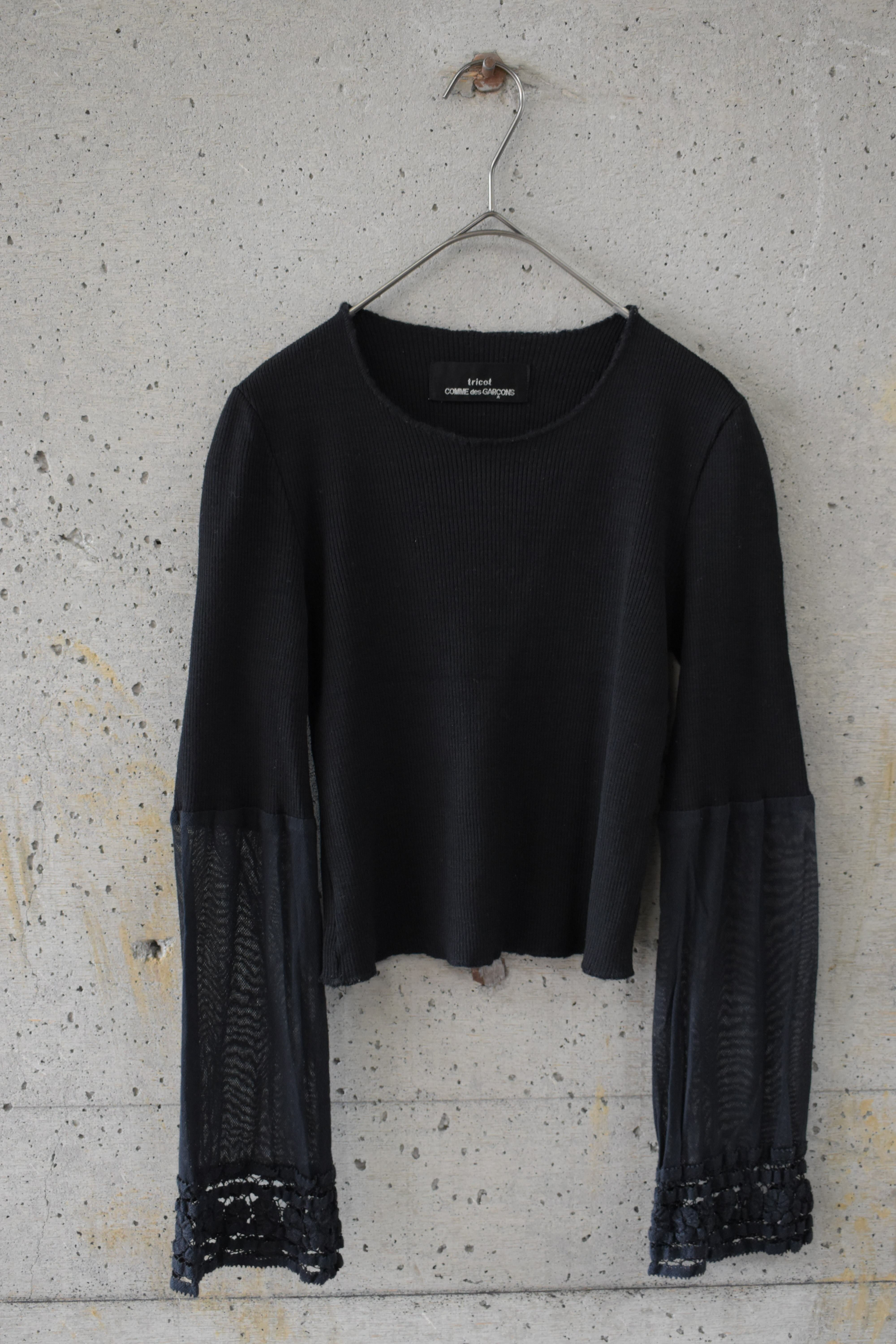 Knit top with contrasting-material sleeve cuffs