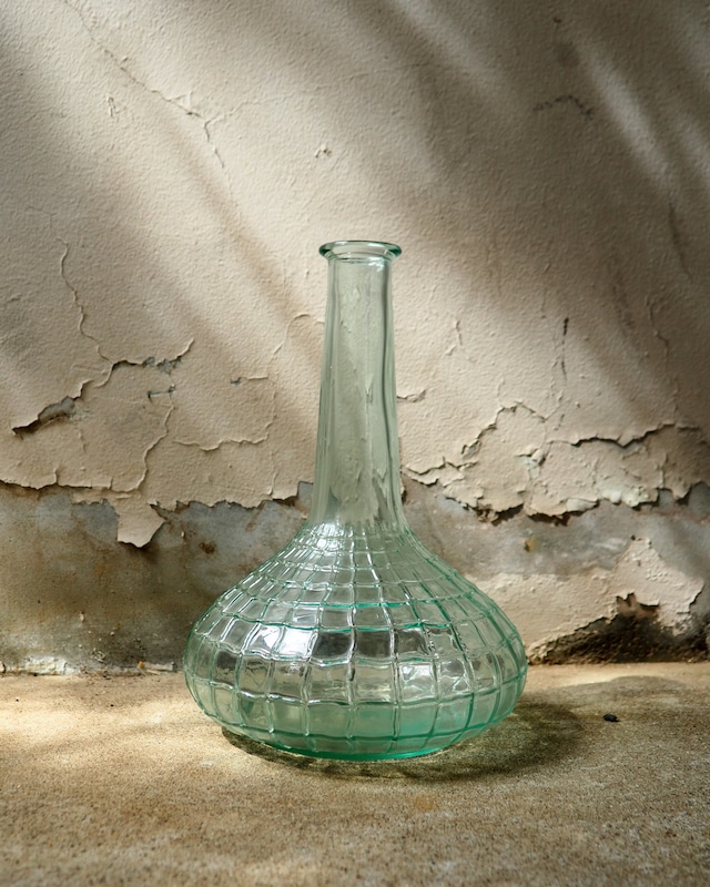 A glass vase resembling a spiderweb
