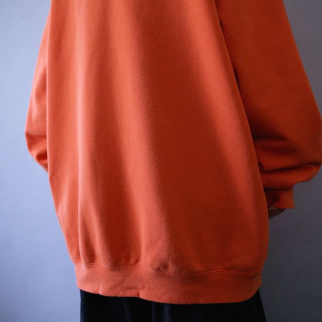 "Carhartt" sleeve logo printed over silhouette orange sweat parka