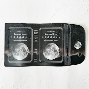 月の事柄が描かれた本のようなブックカバー "RIDE THE MOON" ・手帳カバー