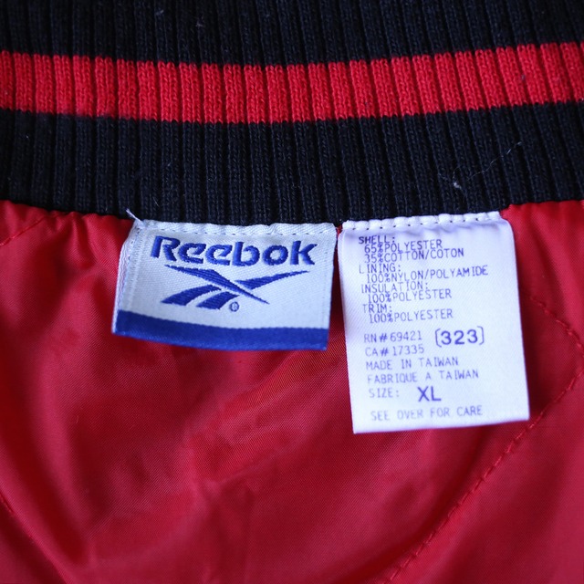 "Reebok" bi-color design over silhouette half-zip sweat pullover