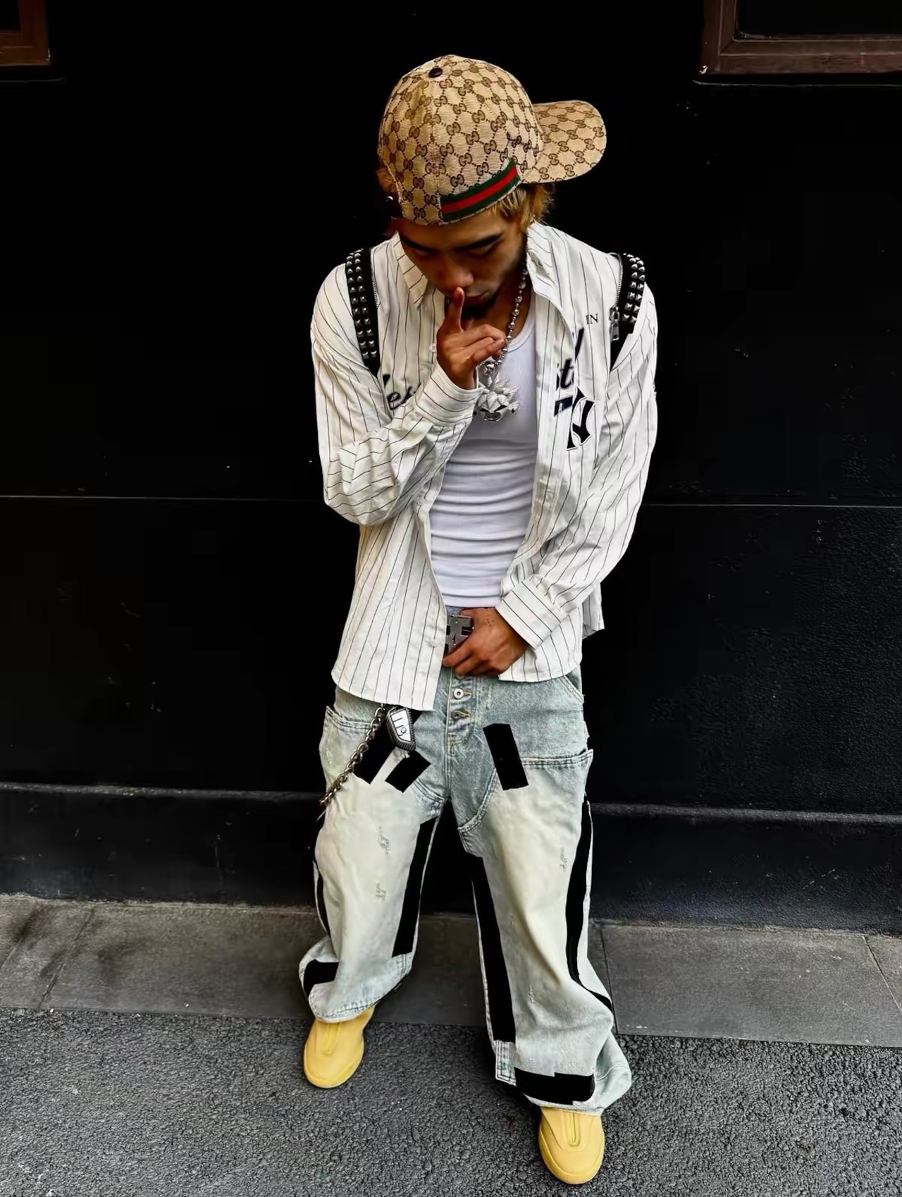 【RYE CHASIN】Duct-taped washed denim jeans