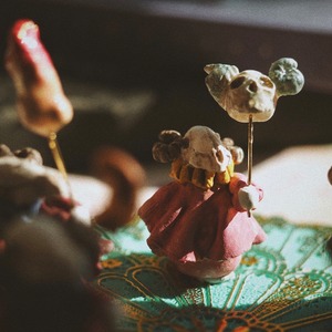 Hand-held doll of a colored bone sheep [skull]