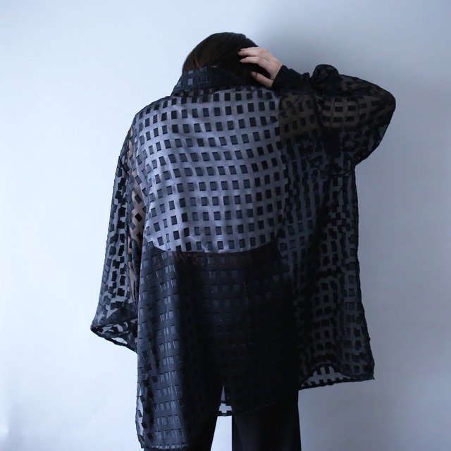 block pattern XXX over silhouette black see-through shirt