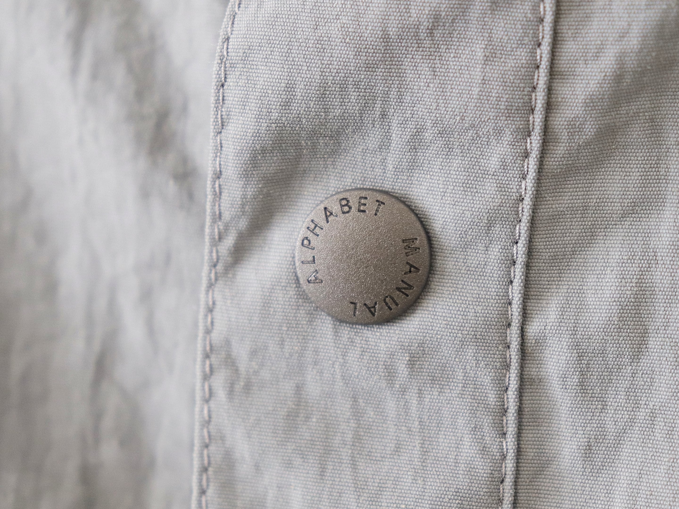 MANUAL ALPHABET / LIGHT SHELL SNAP TEE - GREY マニュアル