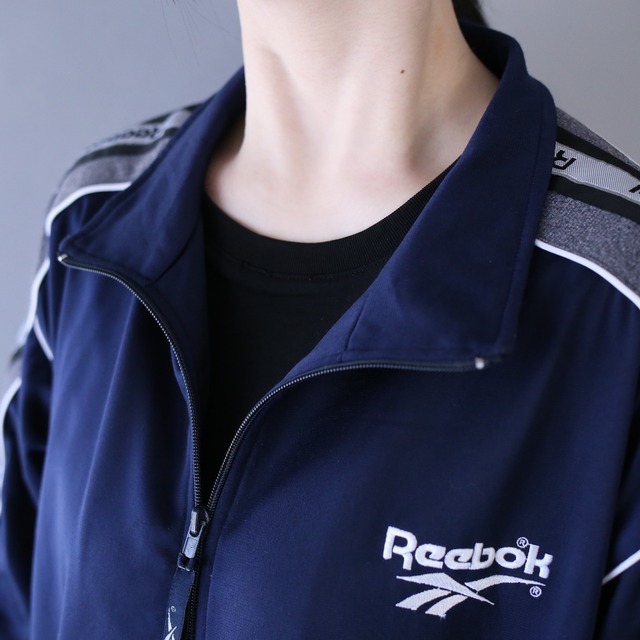 "Reebok" piping and logo taping tech design over silhouette track jacket