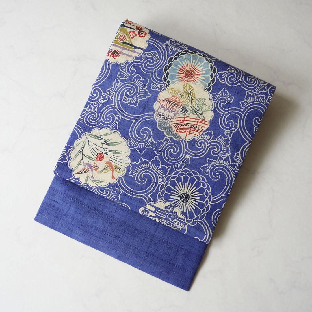 【夏・なごや帯】青色地 唐草に花輪と風景柄 夏紬なごや帯
