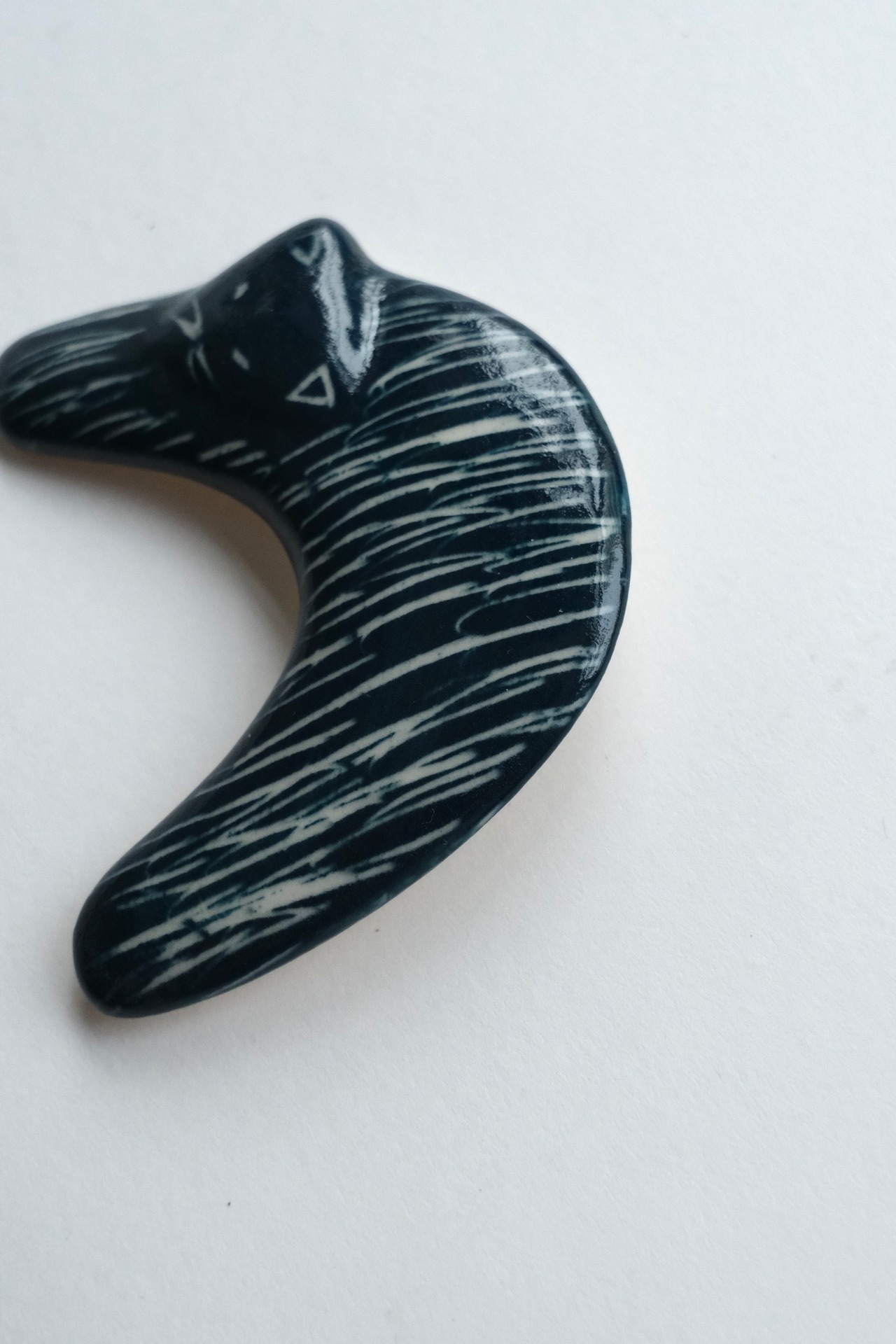 Handmade ceramic crescent cat brooch