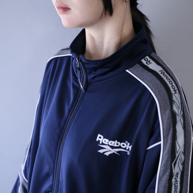 "Reebok" piping and logo taping tech design over silhouette track jacket