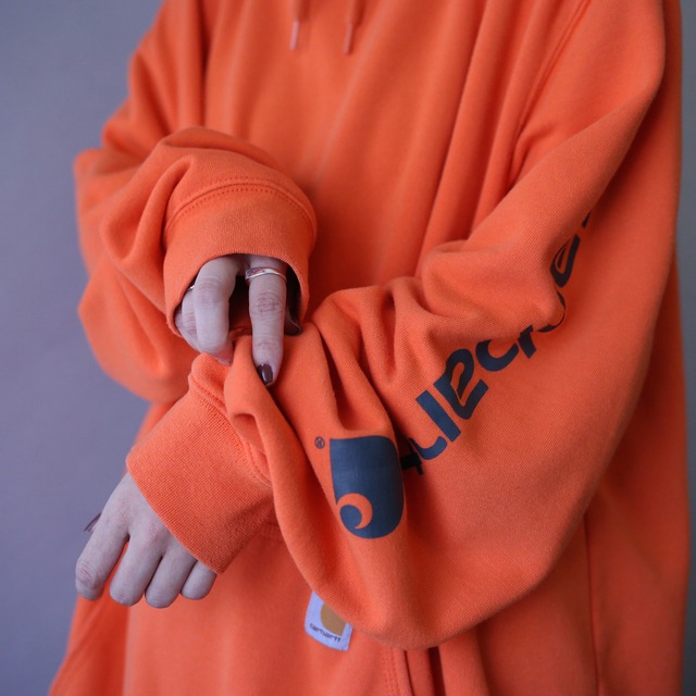 "Carhartt" sleeve logo printed over silhouette orange sweat parka