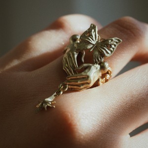 brass ring of spherically-articulated dolls