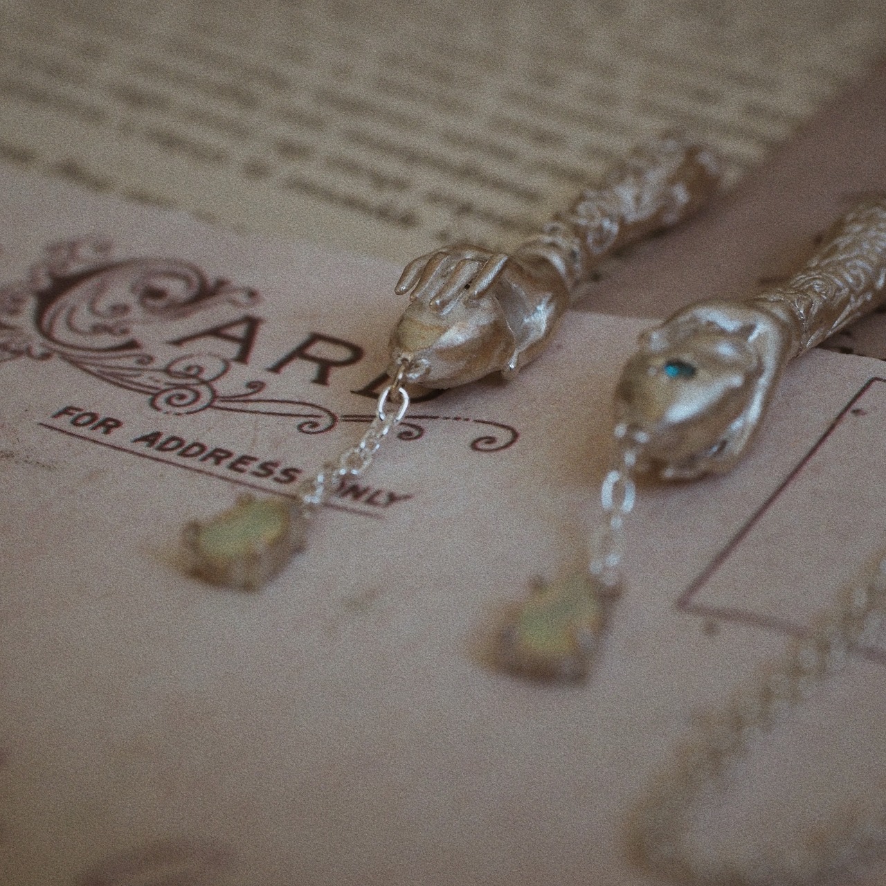 silver necklace of spherically-articulated dolls