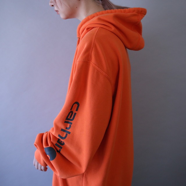 "Carhartt" sleeve logo printed over silhouette orange sweat parka