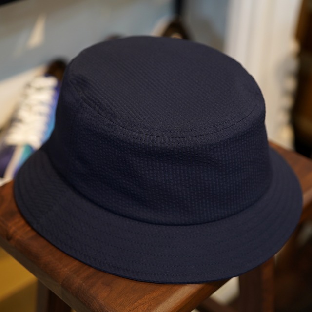 KUON(クオン) CIRCLE別注 ネイビーシアサッカー バケットハット