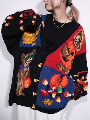 halloween motif graphic design XXX over silhouette cardigan