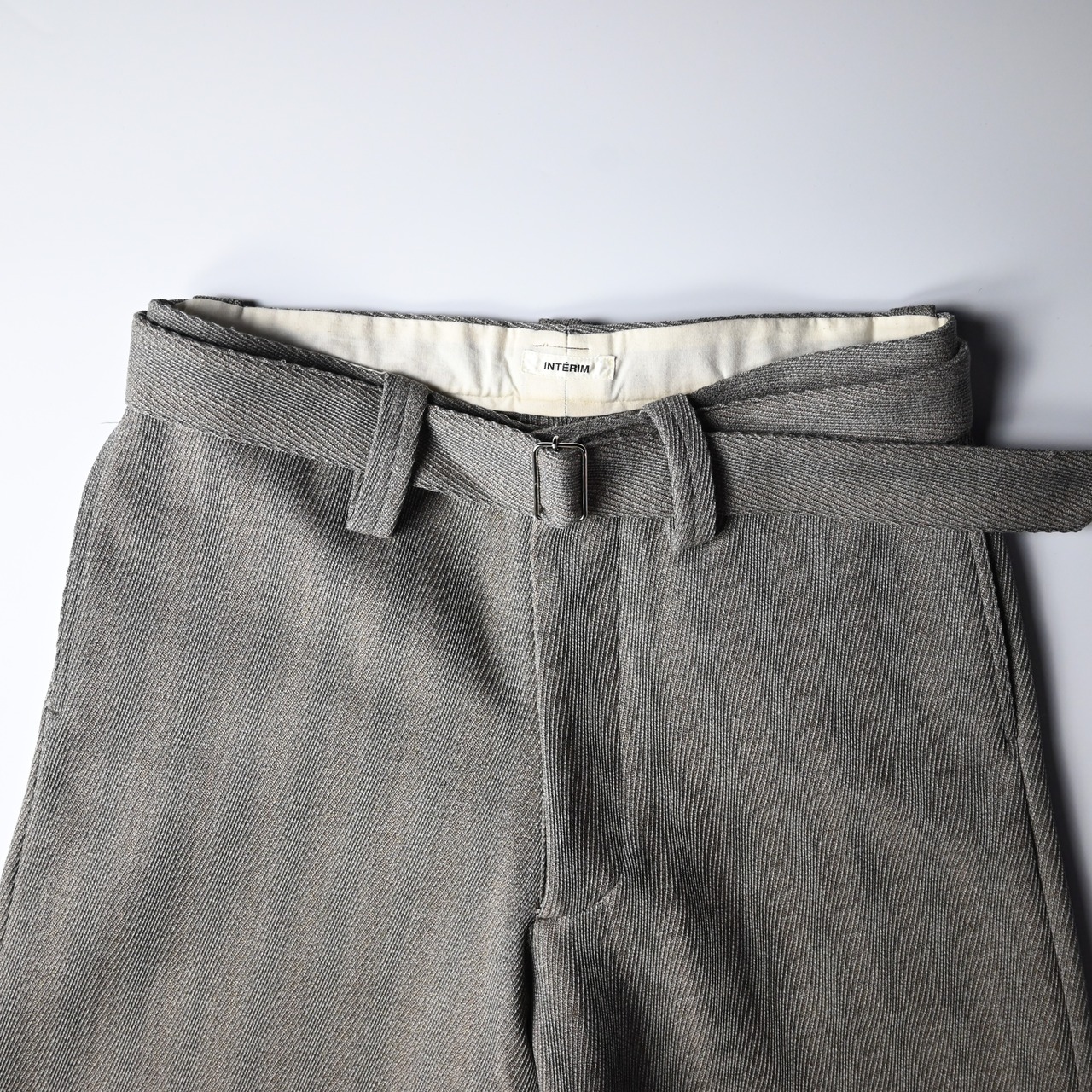 INTERIM / STRUCTURED DIAGONAL MELANGE WOOL DEADSTOCK BELTED MIL BAGGY TROUSER