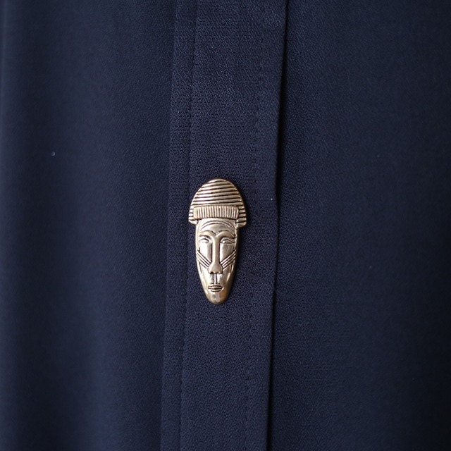 multi gold mask button design over silhouette black shirt