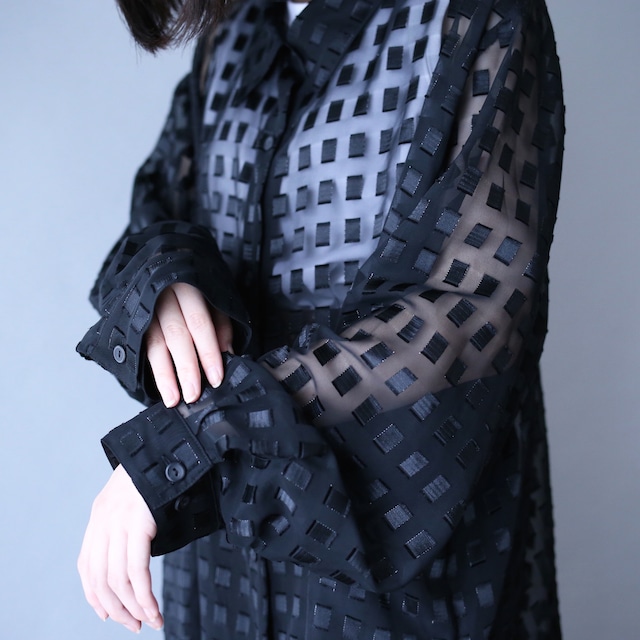 block pattern XXX over silhouette black see-through shirt