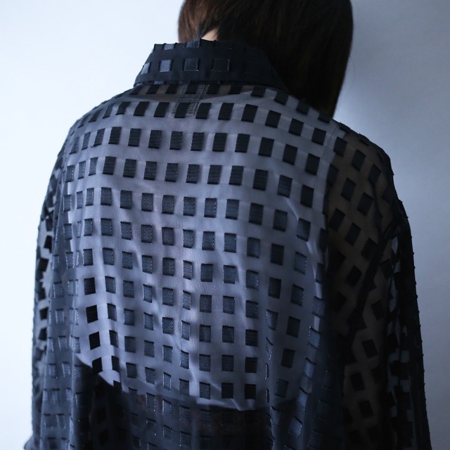 block pattern XXX over silhouette black see-through shirt