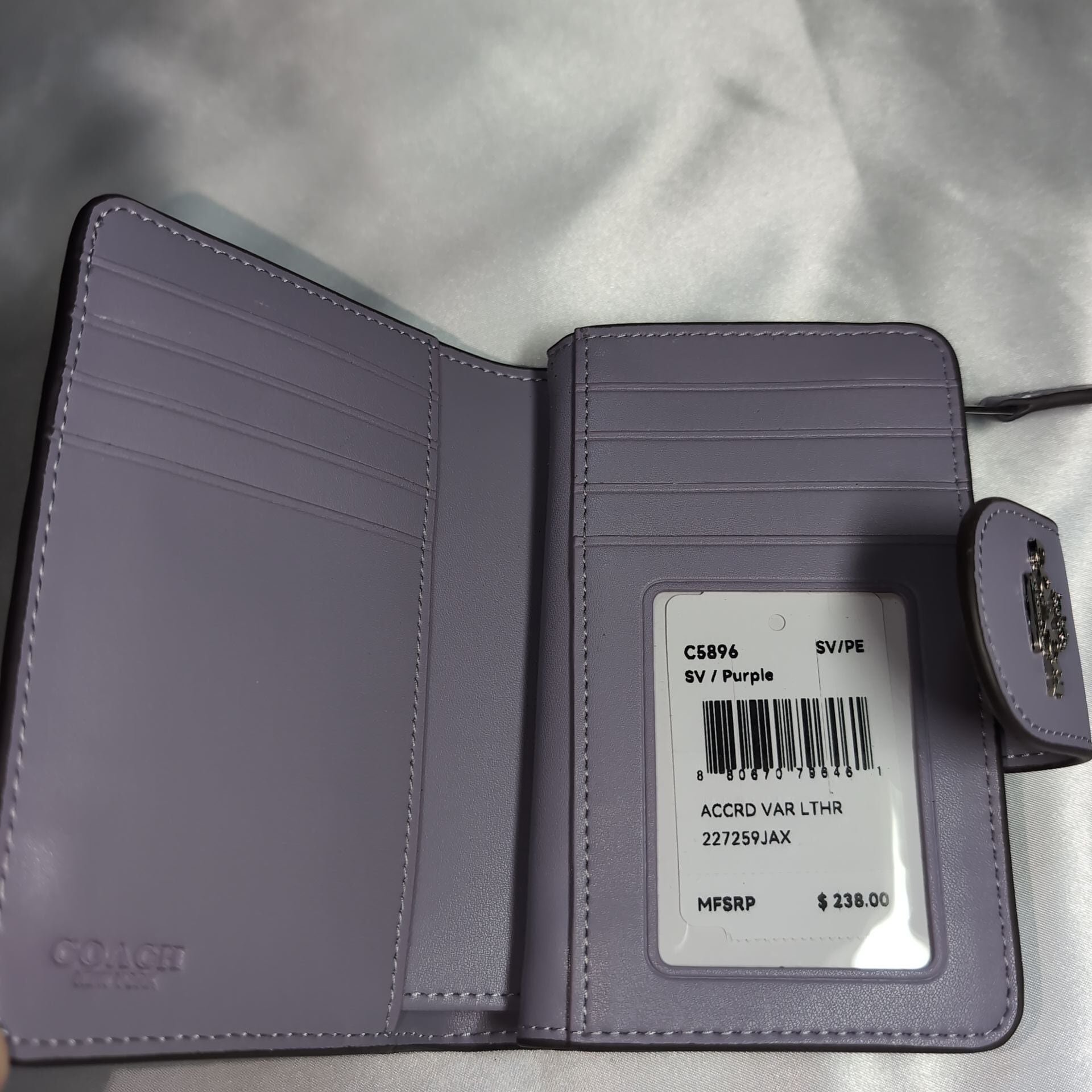 COACHコーチ 二つ折り財布 シグネチャーエンボス パープル | francore