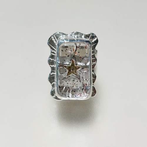 Golden star in quartz ring