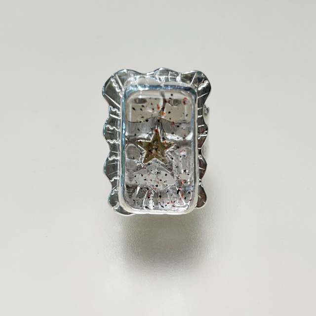 Golden star in quartz ring