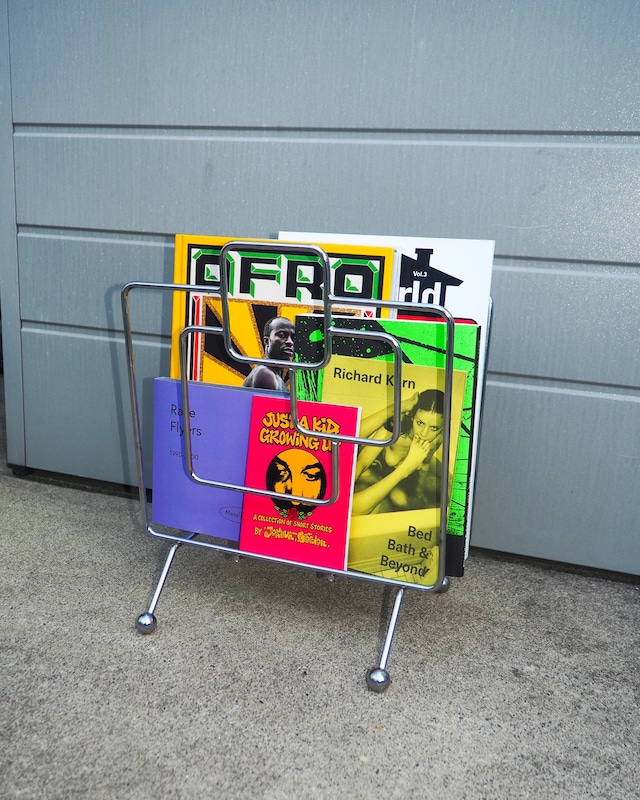 Chrome-plated geometric wireframe magazine rack